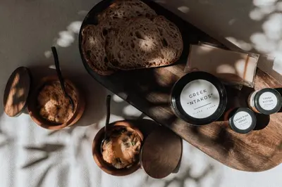 a table with bowls of muffins and candles on it at AthenianNest Asomaton Boutique Studio in Psyrri near Acropolis in Athens