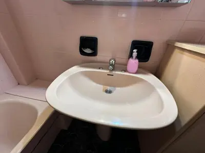 a bathroom sink with a pink soap bottle on it at Kallisto Heart of Athens in Athens