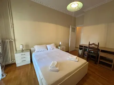 a bedroom with a bed with two towels on it at Kallisto Heart of Athens in Athens