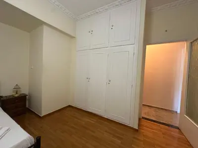 an empty room with white cabinets and a bed at Kallisto Heart of Athens in Athens