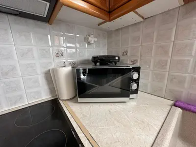 a microwave sitting on a counter in a kitchen at Kallisto Heart of Athens in Athens