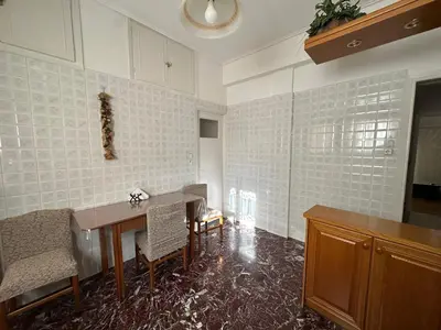 a kitchen with a table and chairs in a room at Kallisto Heart of Athens in Athens
