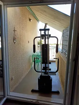 a glass window with a machine in a room at Bright penthouse with amazing panoramic views!!! in Athens