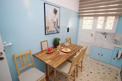 a dining room with a wooden table and a tub at Retro Athens in Athens