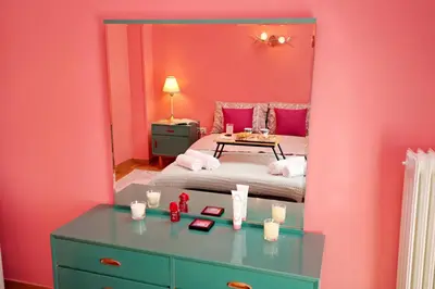 a bedroom with a bed and a mirror at Retro Athens in Athens