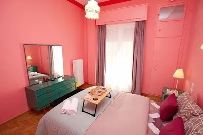 a pink room with a bed and a mirror at Retro Athens in Athens