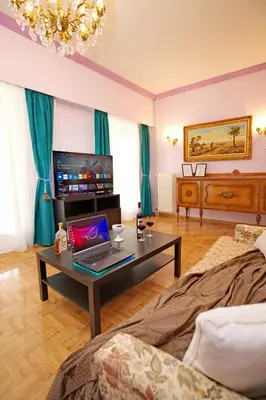 a living room with a laptop on a coffee table at Retro Athens in Athens