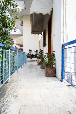 a hallway of a building with plants and a fence at 15 minutes from Athens airport in Porto Rafti