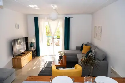 a living room with a couch and a tv at 15 minutes from Athens airport in Porto Rafti