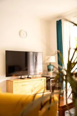 a living room with a couch and a large mirror at 15 minutes from Athens airport in Porto Rafti