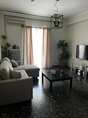 a living room with a couch and a table at Charming Apartment, Walk to Metro & Markets in Athens