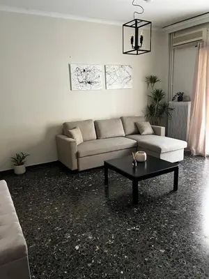 a living room with a couch and a coffee table at Charming Apartment, Walk to Metro & Markets in Athens