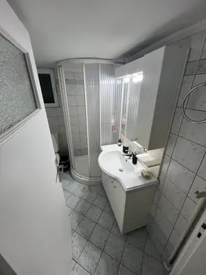 a white bathroom with a sink and a shower at Charming Apartment, Walk to Metro & Markets in Athens