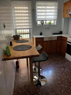 a kitchen with a wooden table in a kitchen at Charming Apartment, Walk to Metro & Markets in Athens