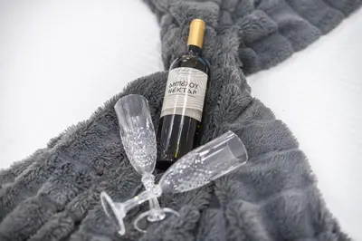 a bottle of wine sitting on top of a mitten at Elegant Dimitra, Your Beautiful Home in Athens, by Acropolin in Athens