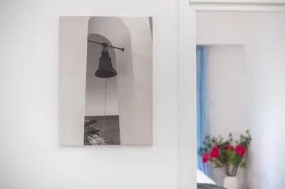 a mirror hanging on a wall in a room at Elegant Dimitra, Your Beautiful Home in Athens, by Acropolin in Athens