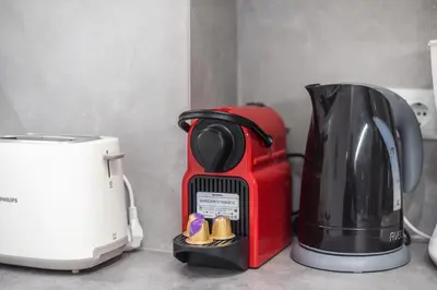 a coffee maker and a toaster on a counter at Elegant Dimitra, Your Beautiful Home in Athens, by Acropolin in Athens