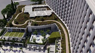 an overhead view of a building with a rooftop garden at Conrad Athens The Ilisian in Athens