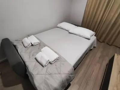 a bedroom with a bed with two pillows on it at RG Living Spaces Neo Psychiko in Athens