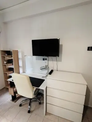 an office with a desk with a computer and a chair at RG Living Spaces Neo Psychiko in Athens
