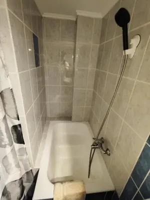 a shower with a white tub in a bathroom at RG Living Spaces Neo Psychiko in Athens