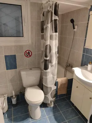a bathroom with a toilet and a sink at RG Living Spaces Neo Psychiko in Athens