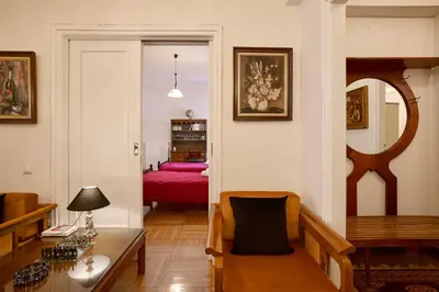 a living room with a table and a bedroom at Kefallinias Classic in Athens