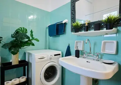 a bathroom with a washing machine and a sink at Kefallinias Classic in Athens