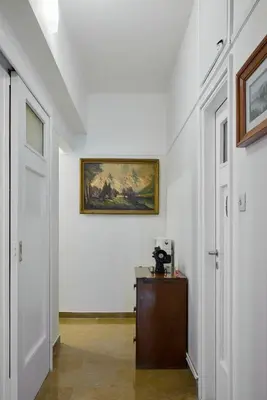 a hallway with white walls and a painting on the wall at Kefallinias Classic in Athens