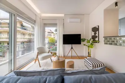 a living room with a couch and a tv at Calming 1BR Apartment with Acropolis view in Athens