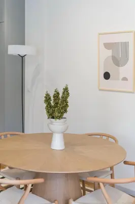 a table with a plant in a vase on it at Calming 1BR Apartment with Acropolis view in Athens