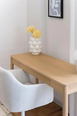 a wooden table with a vase of flowers on it at Calming 1BR Apartment with Acropolis view in Athens