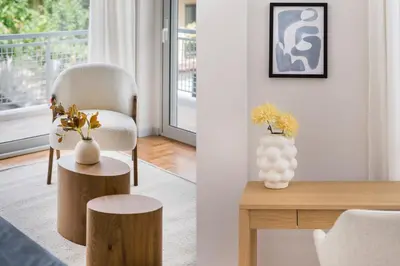 a living room with a table and a chair and a vase at Calming 1BR Apartment with Acropolis view in Athens