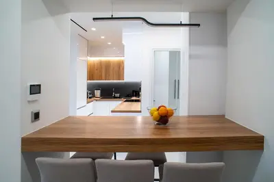 a kitchen with a wooden table and some oranges on it at Filoxenia MG Projects-City Living Metro in Athens