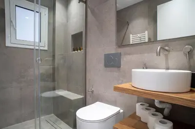 a bathroom with a toilet and a sink and a shower at Filoxenia MG Projects-City Living Metro in Athens