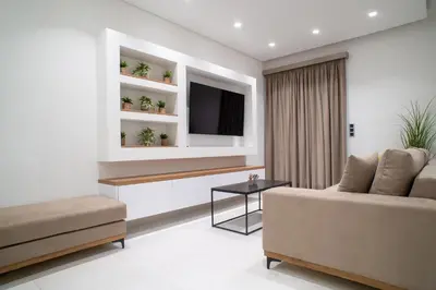 a living room with a couch and a tv at Filoxenia MG Projects-City Living Metro in Athens