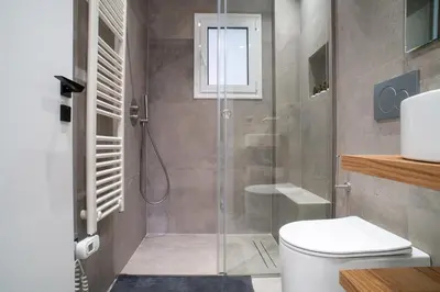 a bathroom with a shower and a toilet at Filoxenia MG Projects-City Living Metro in Athens