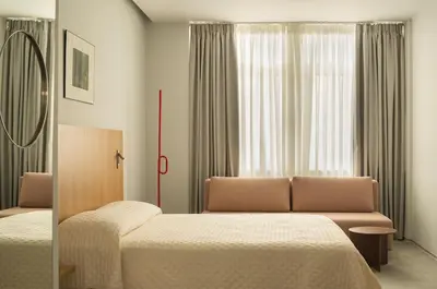 a hotel room with two beds and a couch at P28 Suite 102 in Athens