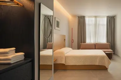 a bedroom with a bed and a mirror at P28 Suite 102 in Athens