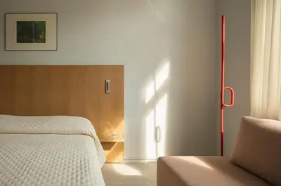 a bedroom with a bed and a window and a chair at P28 Suite 102 in Athens