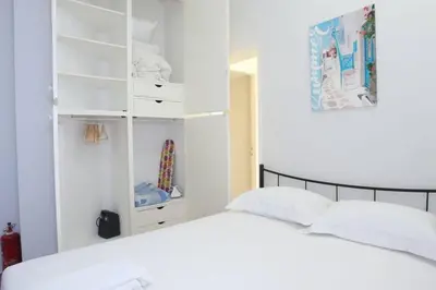 a white bedroom with a bed and a closet at Lovely Studio With Amazing Terrace in Athens