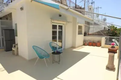 a patio with two chairs and a table at Lovely Studio With Amazing Terrace in Athens