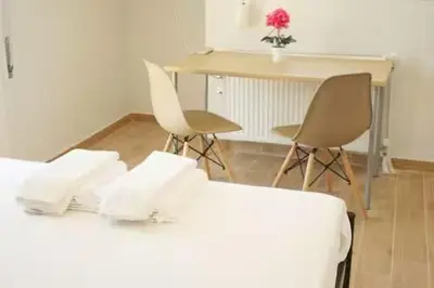 a room with a table and two chairs and a desk at Lovely Studio With Amazing Terrace in Athens