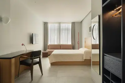 a hotel room with a bed and a desk and a bedroom at P28 Suite 105 in Athens