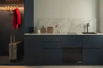 a blue kitchen with a sink and a counter at P28 Suite 105 in Athens