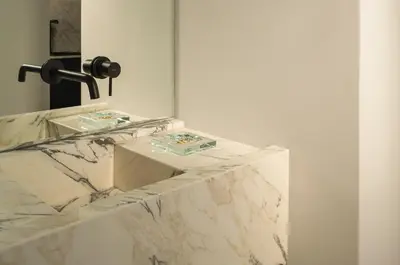a marble bathroom with two sinks and a mirror at P28 Suite 105 in Athens