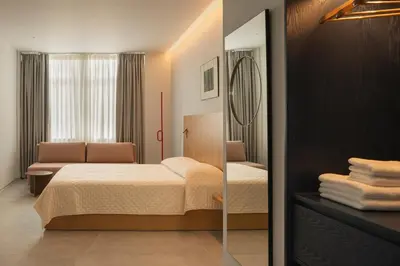a bedroom with a bed and a mirror at P28 Suite 106 in Athens