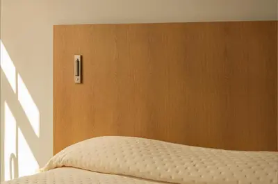 a bedroom with a bed with a wooden headboard at P28 Suite 106 in Athens