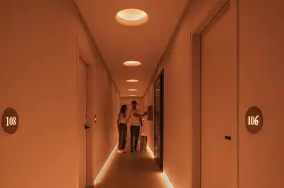 a man and a woman walking down a hallway at P28 Suite 106 in Athens