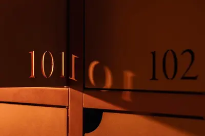 a close up of a metal object with the number at P28 Suite 107 in Athens